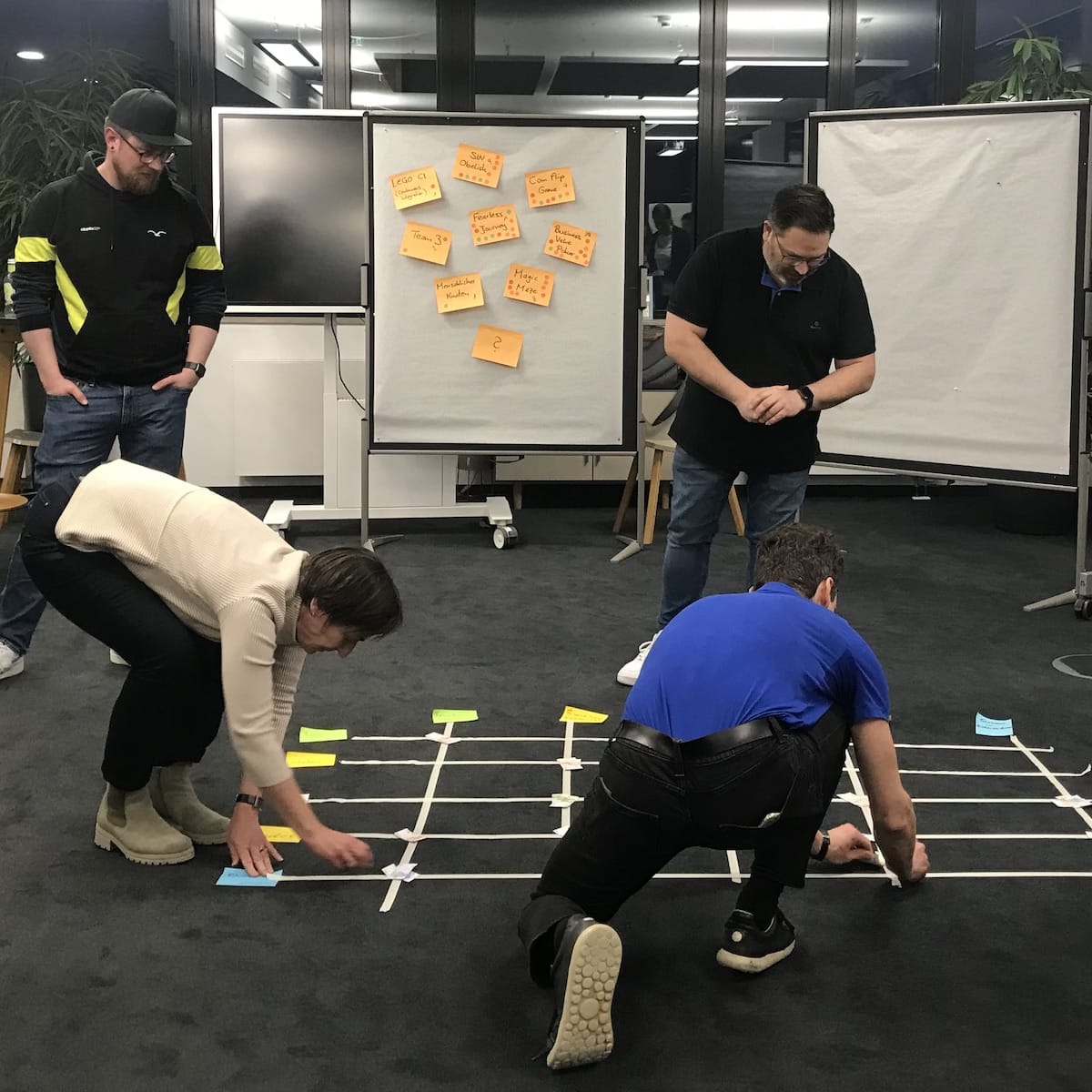 People making a huge matrix at the floor while playing business value poker