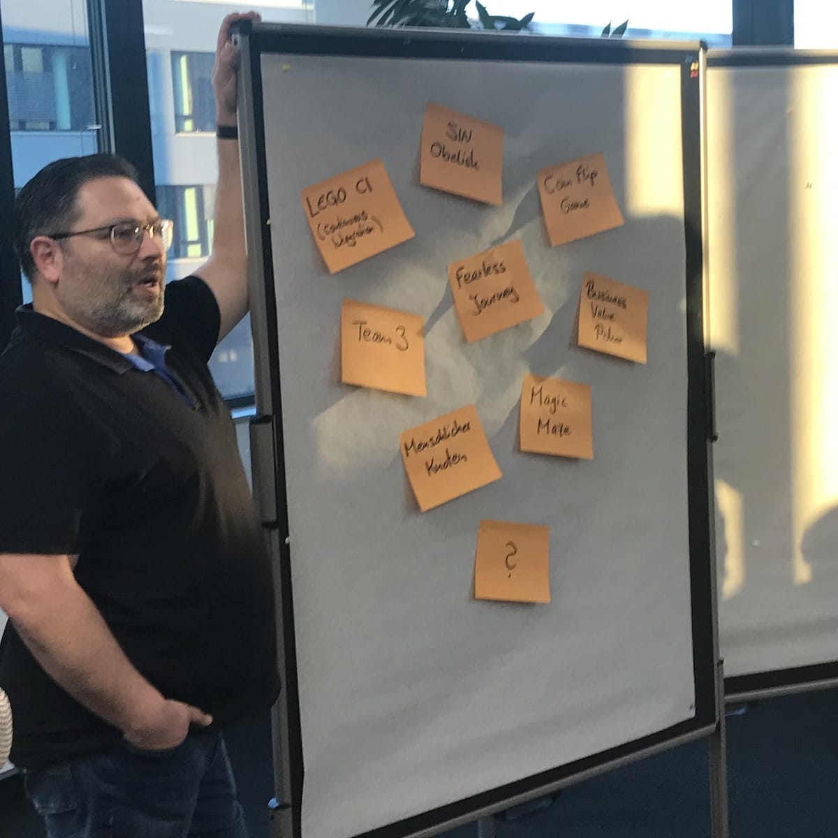 Marc standing next to a board with his game offer for the evening