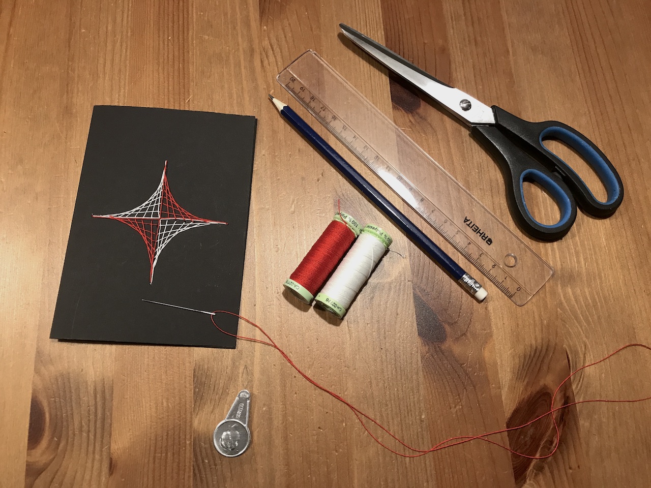 Needle, thread, thin cardboard, scissors, pencil, ruler